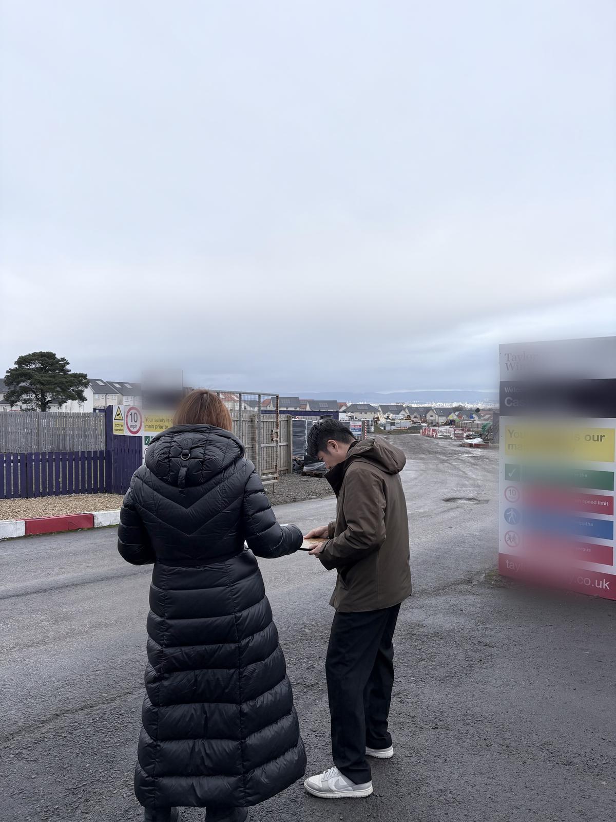 Daniel Siew on site with a project contact at a residential development in Glasgow, Scotland, during an early-stage Feng Shui assessment.